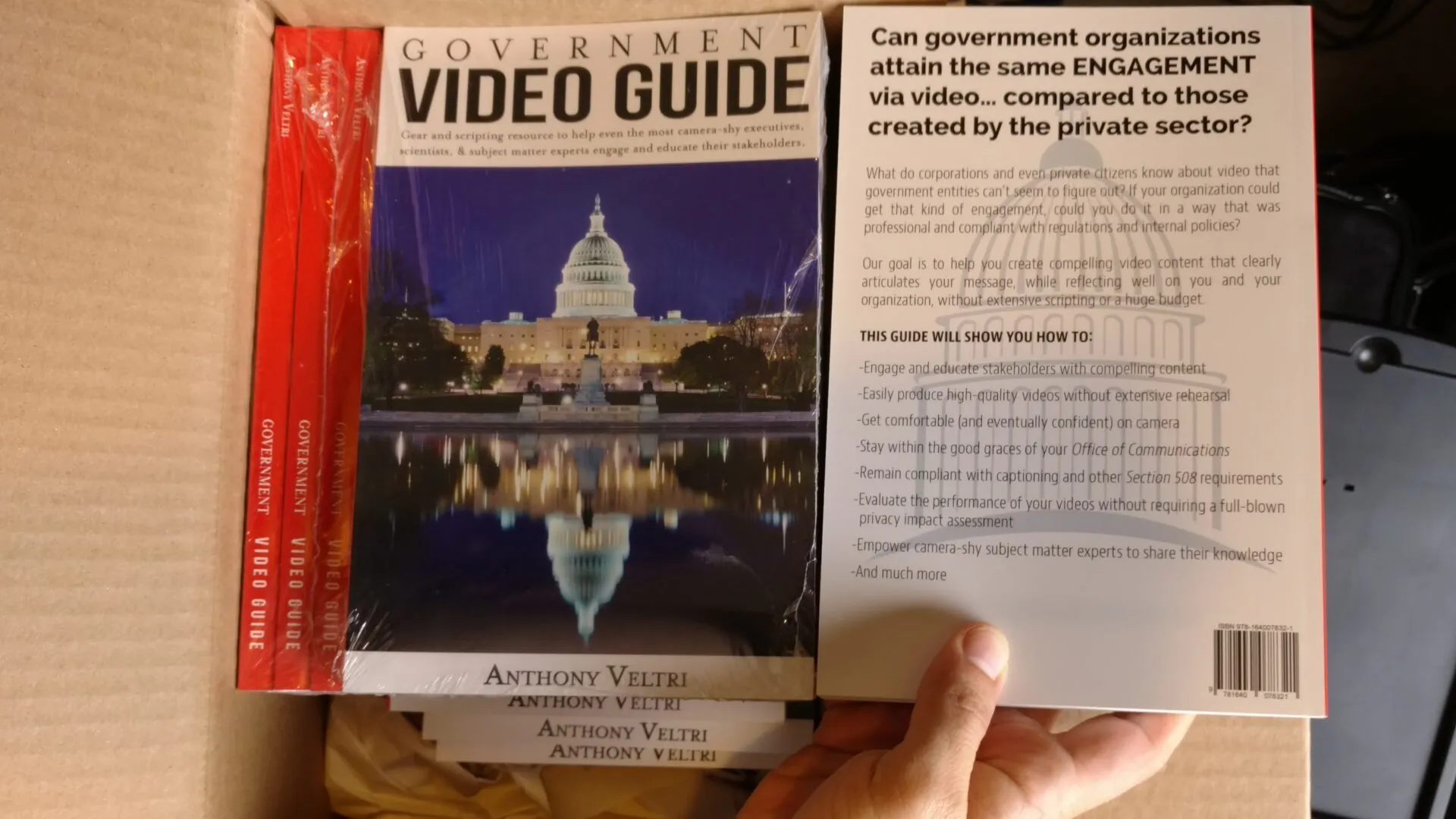 A hand holds a copy of the 