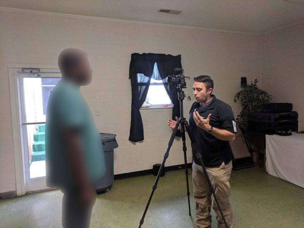 As seen here, a discussion is underway between two individuals in a filming setup, illustrating an interview environment.