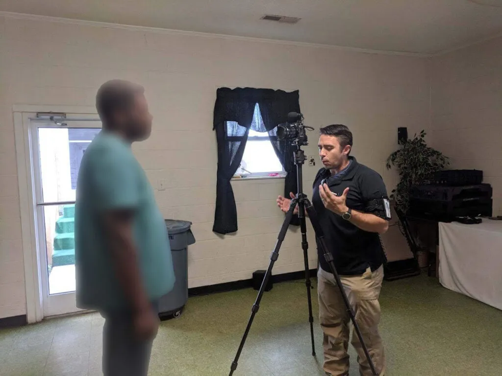 As seen here, a discussion is underway between two individuals in a filming setup, illustrating an interview environment.