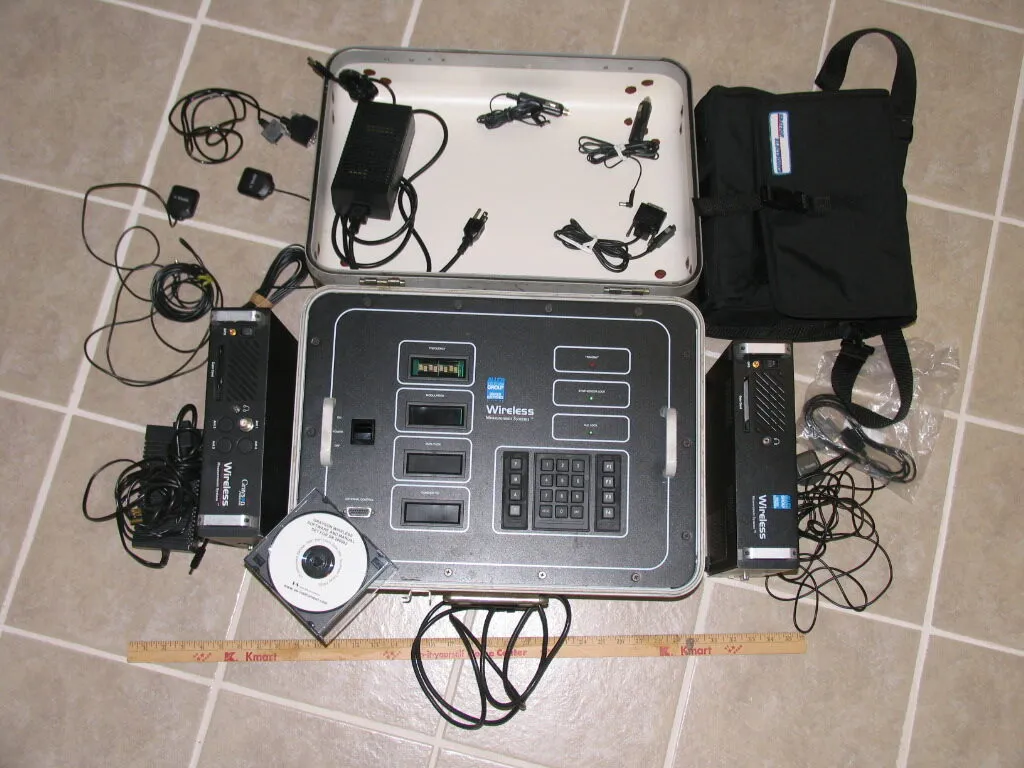 This display illustrates a wireless communications device and its accessories, suggesting a comprehensive equipment assessment scenario.