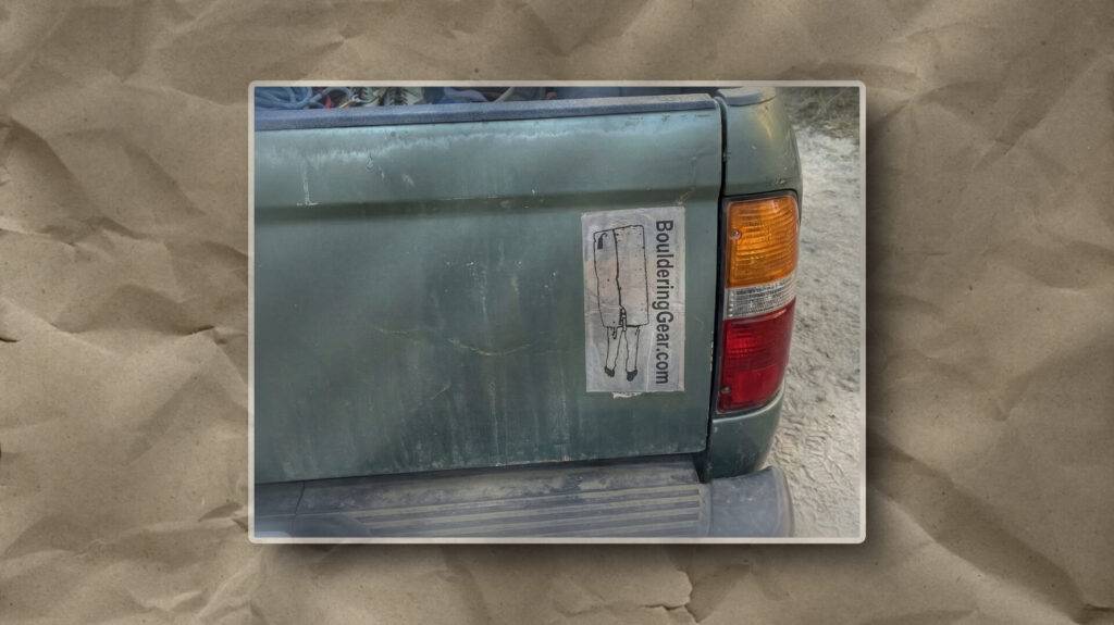 This image illustrates a faded green truck with a peeling gear sticker, suggesting prolonged outdoor use on rugged terrain.
