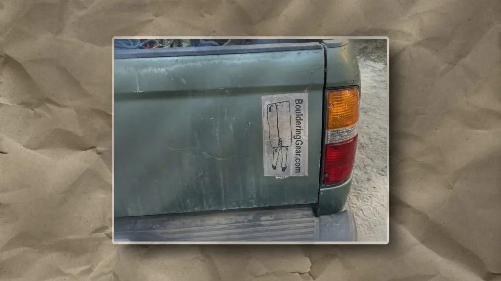 This image illustrates a faded green truck with a peeling gear sticker, suggesting prolonged outdoor use on rugged terrain.