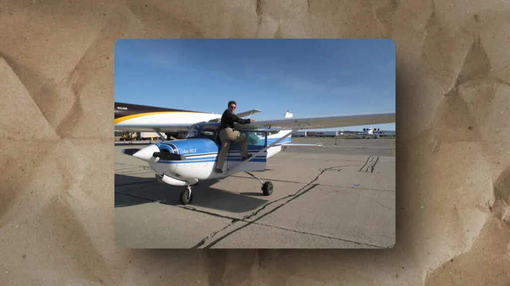 This image illustrates aircraft scale and contrast, as seen by a person seated on a small plane’s wing with a larger plane nearby.