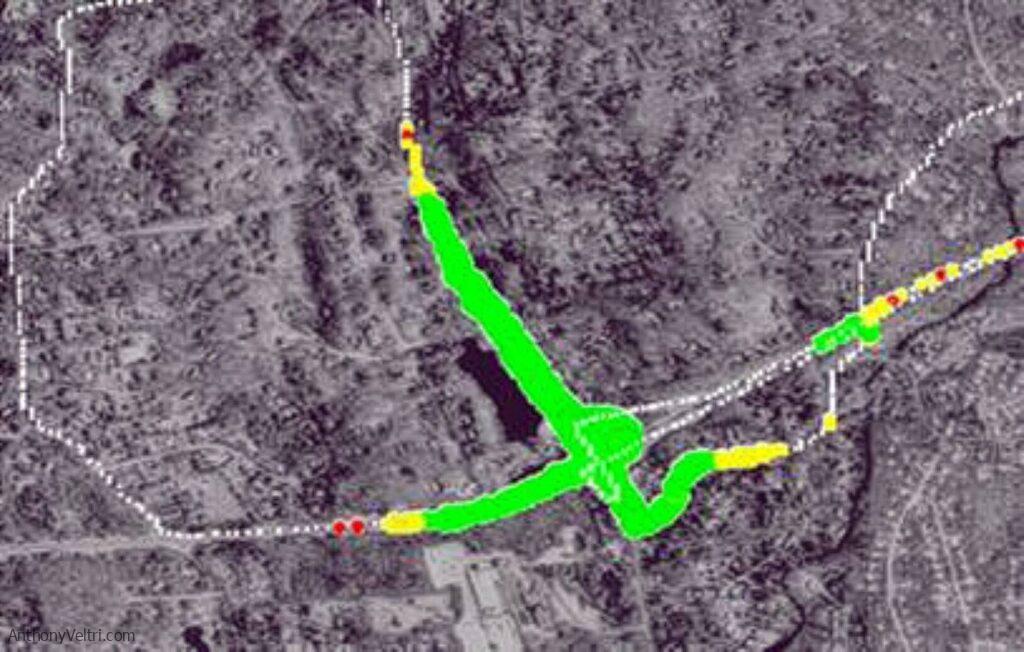 Actual drive test plot showing RSSI coverage from one test site. Green indicates strong signal, yellow is moderate, red is weak or absent. The gap between the intersection and the road to the right isn't a measurement failure. That's a Parkway bridge acting as an RF trap combined with terrain depression. The signal disappeared in the belly of that dip, then reappeared further out where topography allowed. This is why you ground truth instead of trusting propagation models. No model captures 'bridge plus terrain depression' accurately without real measurements.