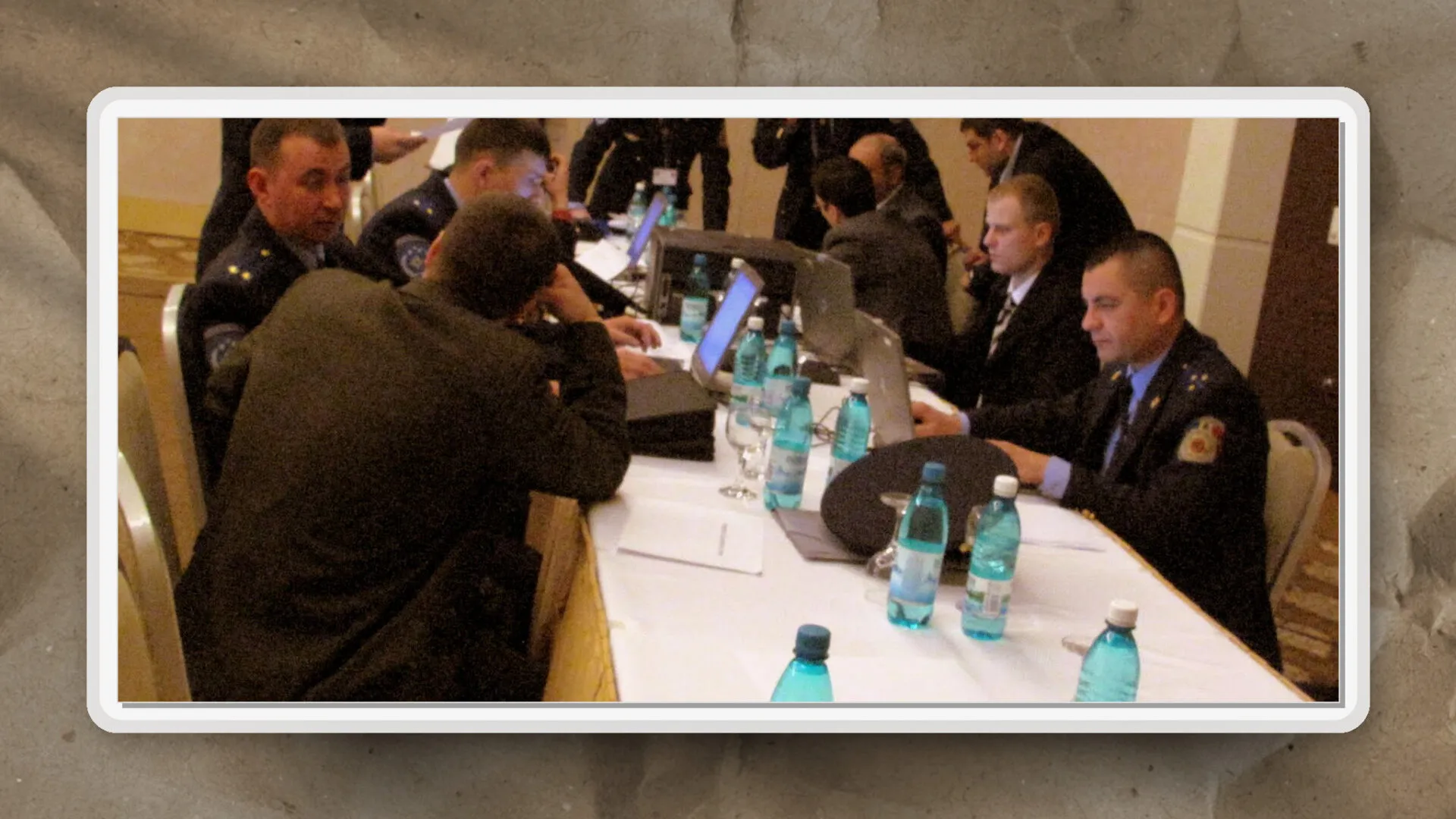 As seen here, participants in formal attire engage in collaborative discussion and analysis during a structured meeting setting.